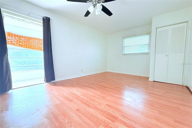 101 Cambridge Trl Unit 194, Sun City Center, FL 33573 - unfurnished bedroom with light wood-style flooring, baseboards, and a ceiling fan
