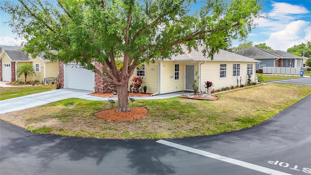 5755 Yorkshire Dr, Zephyrhills, FL 33542 - view of front of house with a front yard, driveway, and an attached garage