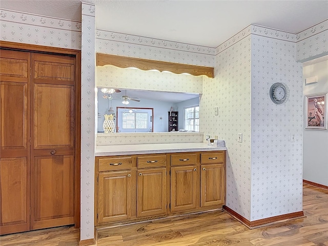 5755 Yorkshire Dr, Zephyrhills, FL 33542 - bathroom with wood finished floors, wallpapered walls, and vanity
