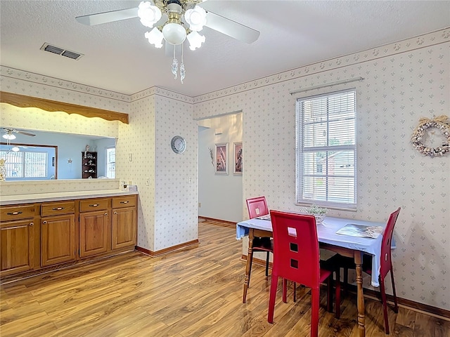 5755 Yorkshire Dr, Zephyrhills, FL 33542 - dining room featuring light wood-type flooring and ceiling fan