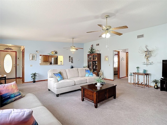 5755 Yorkshire Dr, Zephyrhills, FL 33542 - living area with light colored carpet, ceiling fan, and a textured ceiling