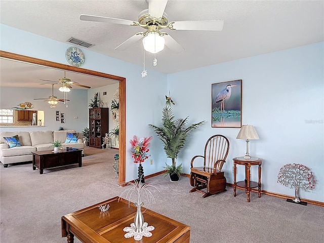 5755 Yorkshire Dr, Zephyrhills, FL 33542 - living area with carpet flooring and a ceiling fan