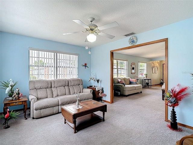 5755 Yorkshire Dr, Zephyrhills, FL 33542 - carpeted living room with a ceiling fan and a textured ceiling