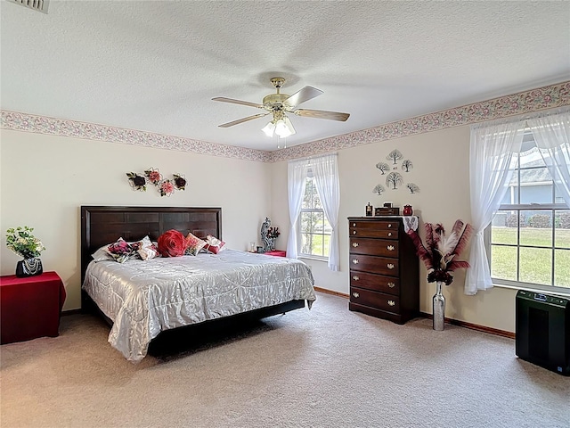 5755 Yorkshire Dr, Zephyrhills, FL 33542 - carpeted bedroom with multiple windows, a textured ceiling, and ceiling fan