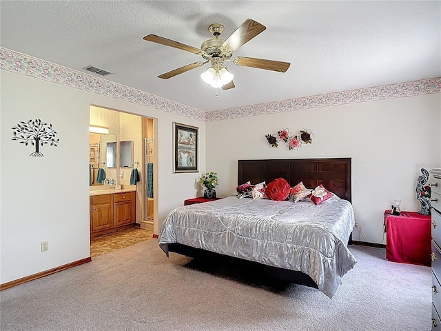 5755 Yorkshire Dr, Zephyrhills, FL 33542 - bedroom featuring light colored carpet, a textured ceiling, ceiling fan, and connected bathroom