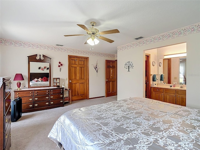 5755 Yorkshire Dr, Zephyrhills, FL 33542 - bedroom featuring light colored carpet, ensuite bath, and ceiling fan