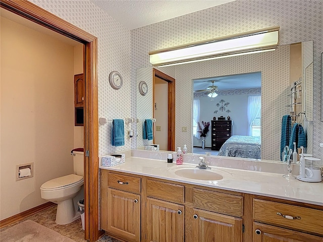 5755 Yorkshire Dr, Zephyrhills, FL 33542 - bathroom featuring ensuite bathroom, wallpapered walls, vanity, ceiling fan, and a textured ceiling