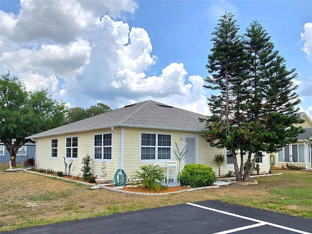 5755 Yorkshire Dr, Zephyrhills, FL 33542 - view of front of home with a front lawn and roof with shingles