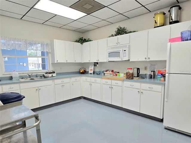 5755 Yorkshire Dr, Zephyrhills, FL 33542 - kitchen featuring white appliances, white cabinetry, and light countertops