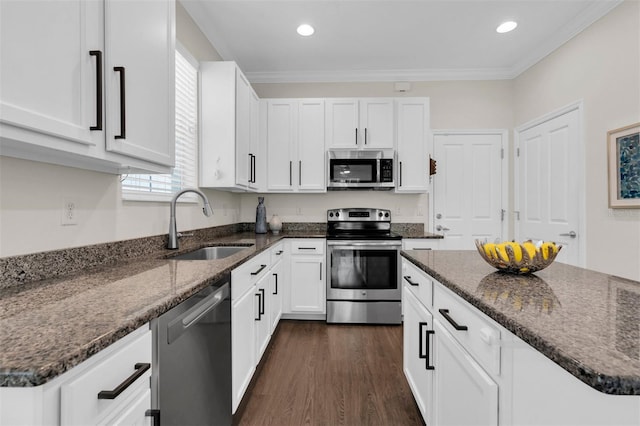 106 Cutlass Way, Oldsmar, FL 34677 - kitchen with appliances with stainless steel finishes, dark stone counters, white cabinetry, dark wood-type flooring, and recessed lighting