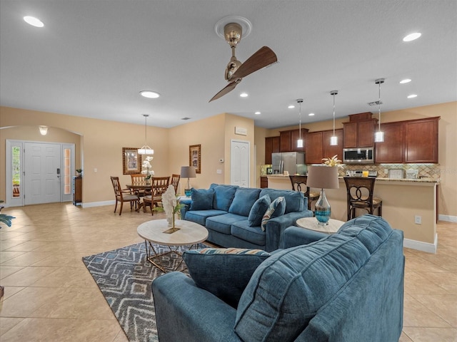 27546 Stonecreek Way, Wesley Chapel, FL 33544 - living area with light tile patterned floors, arched walkways, recessed lighting, and ceiling fan