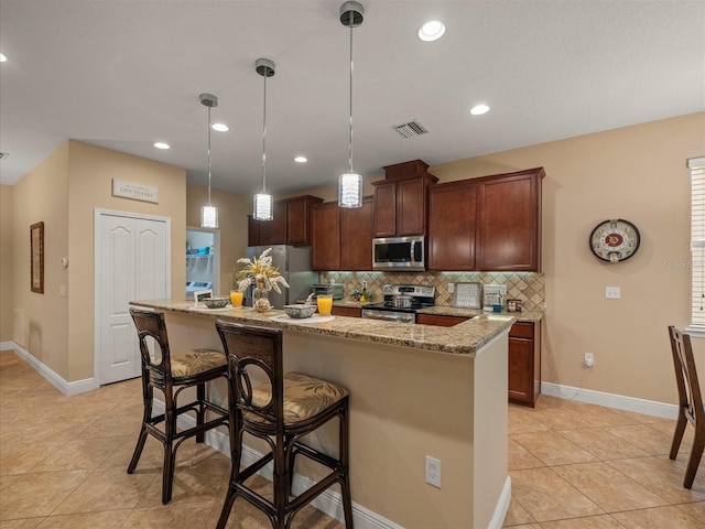 27546 Stonecreek Way, Wesley Chapel, FL 33544 - kitchen with appliances with stainless steel finishes, tasteful backsplash, light tile patterned floors, light stone counters, and recessed lighting