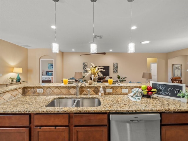 27546 Stonecreek Way, Wesley Chapel, FL 33544 - kitchen with stainless steel dishwasher, arched walkways, pendant lighting, light stone counters, and recessed lighting