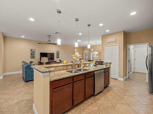 27546 Stonecreek Way, Wesley Chapel, FL 33544 - kitchen featuring stainless steel appliances, light tile patterned floors, open floor plan, recessed lighting, and hanging light fixtures