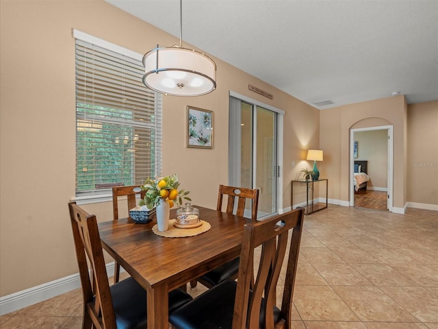 27546 Stonecreek Way, Wesley Chapel, FL 33544 - dining area with arched walkways and light tile patterned floors