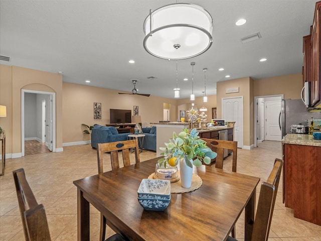 27546 Stonecreek Way, Wesley Chapel, FL 33544 - dining area featuring light tile patterned flooring, ceiling fan, recessed lighting, and arched walkways