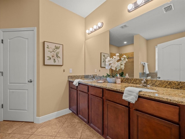 27546 Stonecreek Way, Wesley Chapel, FL 33544 - bathroom with double vanity, tile patterned floors, and a tile shower