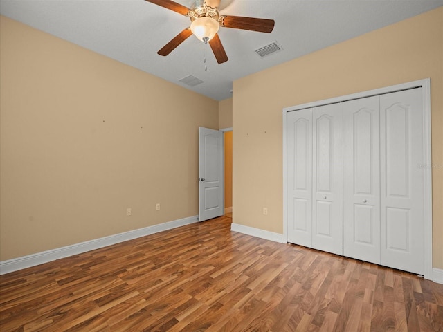 27546 Stonecreek Way, Wesley Chapel, FL 33544 - unfurnished bedroom with wood finished floors, a closet, and a ceiling fan