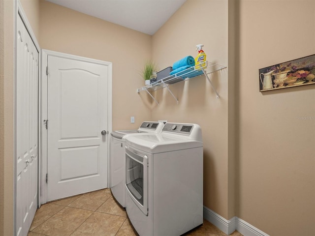 27546 Stonecreek Way, Wesley Chapel, FL 33544 - laundry room with washing machine and clothes dryer and light tile patterned floors