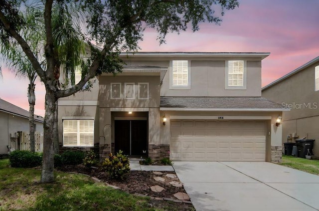 5916 Tulip Flower Dr, Riverview, FL 33578 - view of front of home with stucco siding, concrete driveway, an attached garage, and stone siding