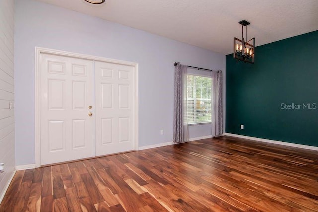 5916 Tulip Flower Dr, Riverview, FL 33578 - unfurnished bedroom featuring wood finished floors and a chandelier