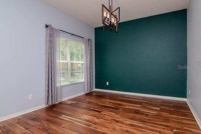 5916 Tulip Flower Dr, Riverview, FL 33578 - empty room featuring wood finished floors and a chandelier