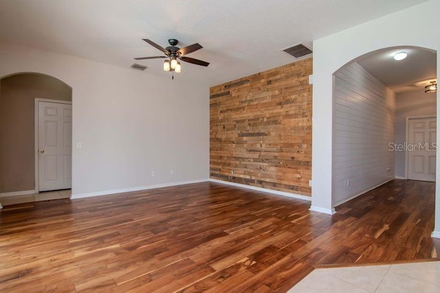 5916 Tulip Flower Dr, Riverview, FL 33578 - spare room featuring a ceiling fan, wood finished floors, and arched walkways