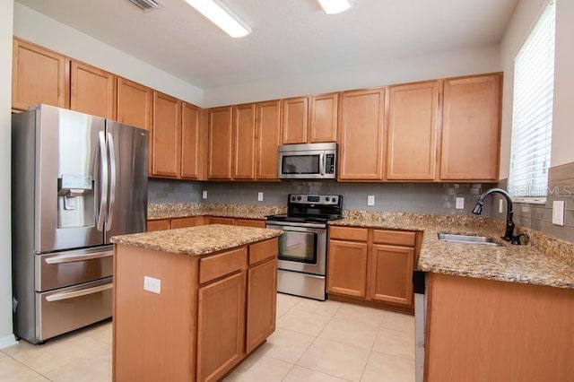 5916 Tulip Flower Dr, Riverview, FL 33578 - kitchen with appliances with stainless steel finishes, light stone countertops, a center island, light tile patterned flooring, and decorative backsplash