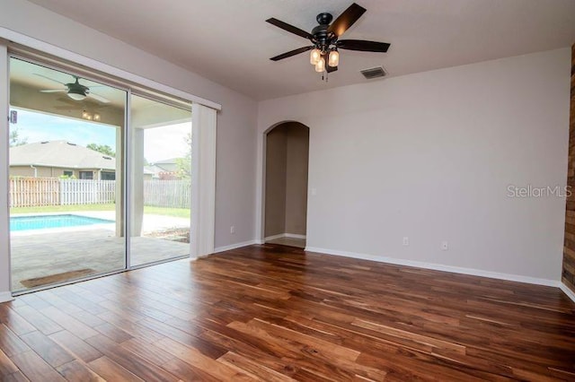 5916 Tulip Flower Dr, Riverview, FL 33578 - spare room with arched walkways, a ceiling fan, and wood finished floors