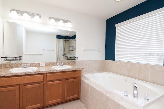 5916 Tulip Flower Dr, Riverview, FL 33578 - bathroom with a stall shower, a garden tub, tile patterned floors, and double vanity