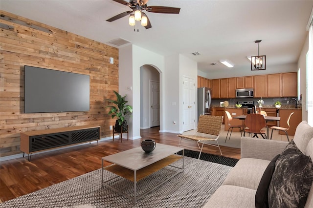 5916 Tulip Flower Dr, Riverview, FL 33578 - living room featuring wood walls, arched walkways, wood finished floors, and ceiling fan