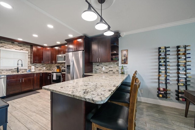 1230 Gulf Blvd Unit 304, Clearwater, FL 33767 - kitchen featuring stainless steel appliances, ornamental molding, light wood-type flooring, tasteful backsplash, and open shelves
