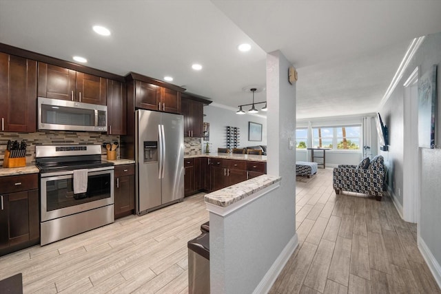 1230 Gulf Blvd Unit 304, Clearwater, FL 33767 - kitchen featuring appliances with stainless steel finishes, ornamental molding, dark brown cabinetry, decorative backsplash, and baseboards