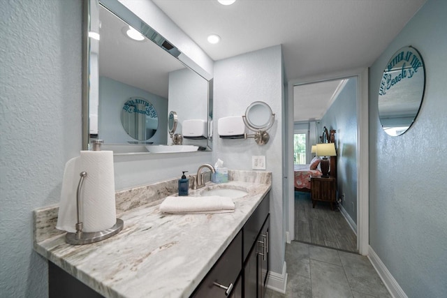 1230 Gulf Blvd Unit 304, Clearwater, FL 33767 - bathroom with ensuite bathroom, a textured wall, vanity, tile patterned floors, and baseboards