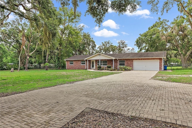 11029 Clay Pit Rd, Tampa, FL 33610 - single story home featuring brick siding, a garage, and decorative driveway