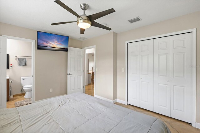 11029 Clay Pit Rd, Tampa, FL 33610 - bedroom with a closet, baseboards, light tile patterned flooring, and a ceiling fan