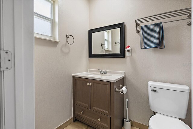 11029 Clay Pit Rd, Tampa, FL 33610 - bathroom with toilet, vanity, and baseboards
