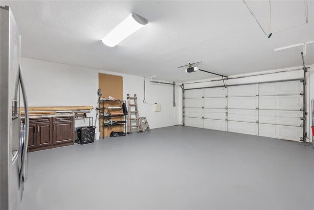 11029 Clay Pit Rd, Tampa, FL 33610 - garage featuring a garage door opener and freestanding refrigerator