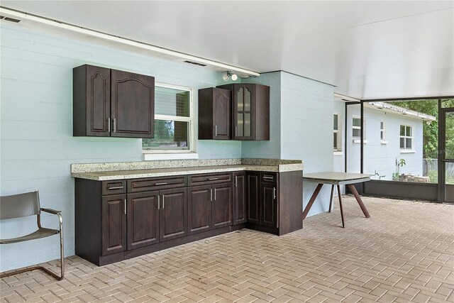 11029 Clay Pit Rd, Tampa, FL 33610 - kitchen with light countertops and dark brown cabinets