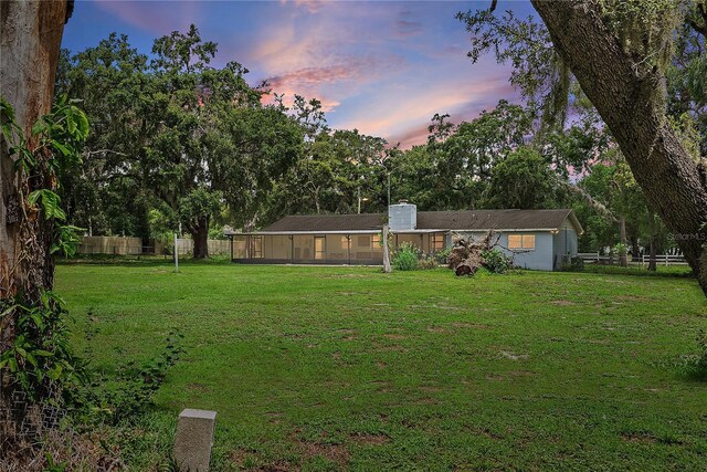 11029 Clay Pit Rd, Tampa, FL 33610 - view of yard featuring a sunroom and view of wooded area