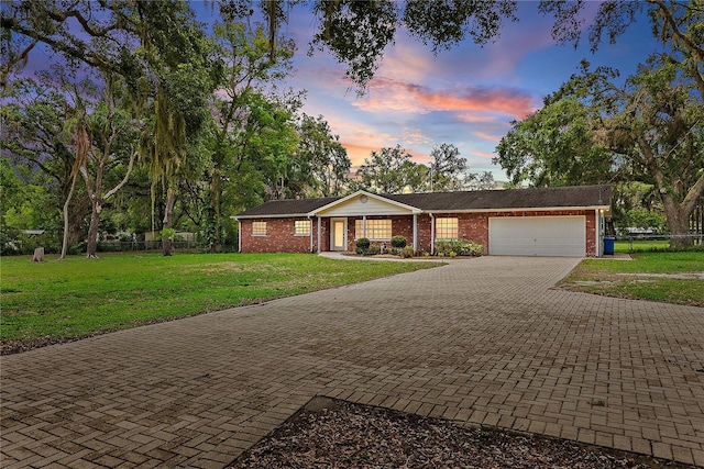 11029 Clay Pit Rd, Tampa, FL 33610 - ranch-style home featuring brick siding, an attached garage, decorative driveway, and a porch