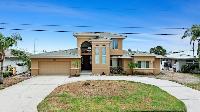 333 Midway Is, Clearwater Beach, FL 33767 - view of front of property with driveway, stucco siding, a garage, and a tiled roof