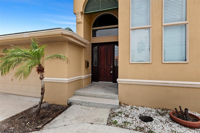 333 Midway Is, Clearwater Beach, FL 33767 - view of exterior entry with stucco siding and driveway