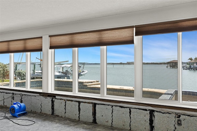 333 Midway Is, Clearwater Beach, FL 33767 - unfurnished sunroom with a water view, plenty of natural light, and crown molding