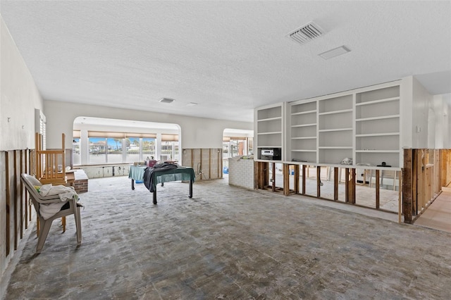 333 Midway Is, Clearwater Beach, FL 33767 - sitting room with a textured ceiling, arched walkways, and carpet
