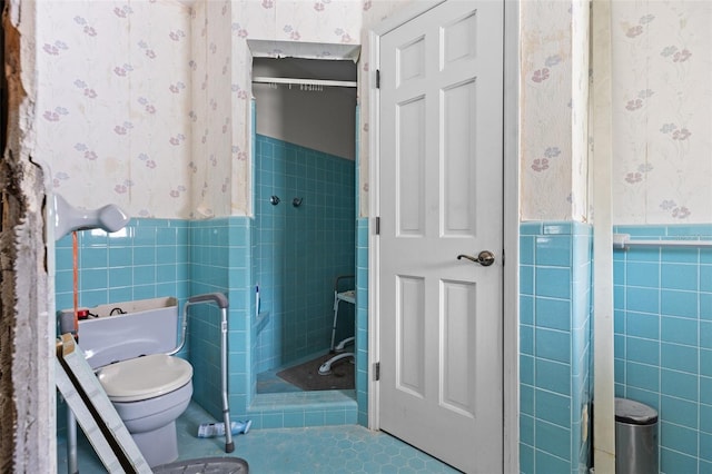 333 Midway Is, Clearwater Beach, FL 33767 - full bathroom with wallpapered walls, tile walls, wainscoting, a shower stall, and tile patterned floors