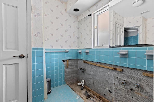 333 Midway Is, Clearwater Beach, FL 33767 - bathroom featuring wallpapered walls, a wainscoted wall, tile walls, and tile patterned floors