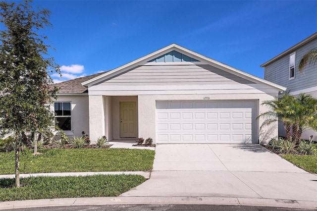 1201 Tidal St, Haines City, FL 33844 - ranch-style house with an attached garage, concrete driveway, a front yard, and stucco siding