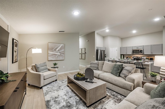 1201 Tidal St, Haines City, FL 33844 - living area with light wood-style flooring, baseboards, and recessed lighting