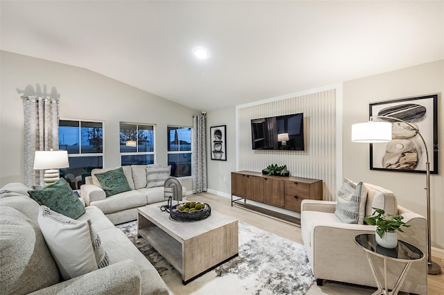 1201 Tidal St, Haines City, FL 33844 - living room with light wood finished floors, lofted ceiling, and baseboards